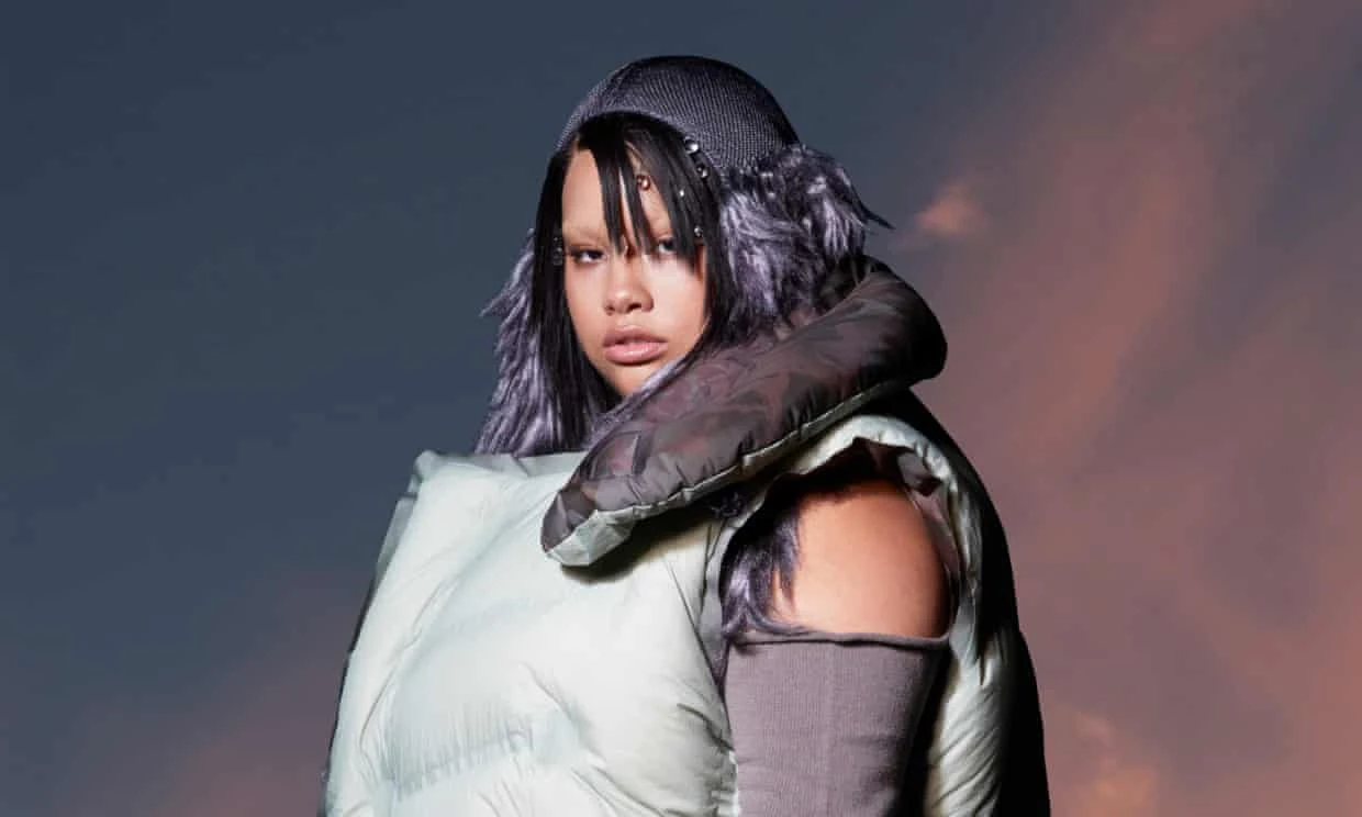 Pop artist Shygirl dressed in silver and purple.
