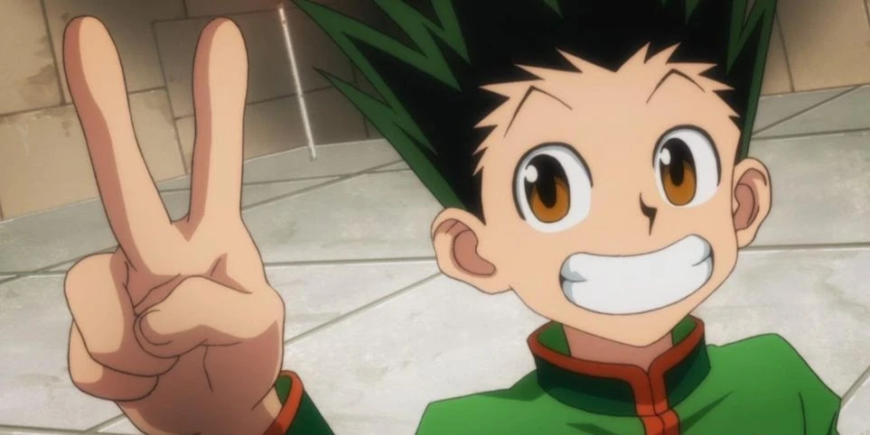 Gon Freecss smiles widely and gives a peace sign