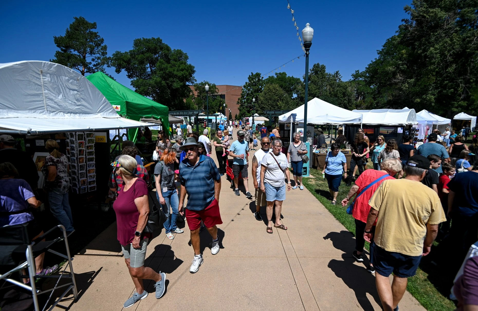 GREELEY, CO - JULY 30:Visitors walk through rows of booths during the annual Greeley Arts Picnic at Lincoln Park in downtown Greeley on July 30, 2022.  The event features performances, exhibitions by local artists, food and activities for children.  (Alex McIntyre/Staff Photographer)